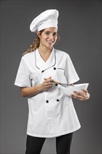 Portrait female chef with bowl mixing