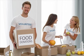 Volunteers with boxes food charity