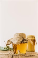 Fresh honey closed jar wooden surface