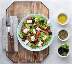 Top view salad with feta cheese cutting board with olives