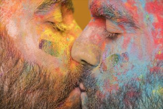 Kissing couple rainbow painted homosexual men