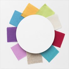 Colorful pieces cloths arrangement with white circle centered