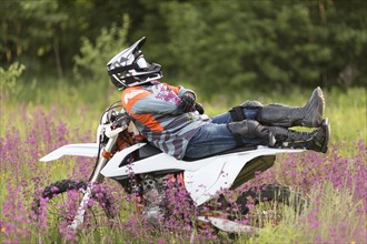 Stylish man relaxing top motorbike