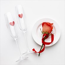 Arrangement with champagne glasses white background