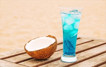 Cracked coconut glass bright blue drink wooden table