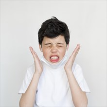 Front view young boy sneezing