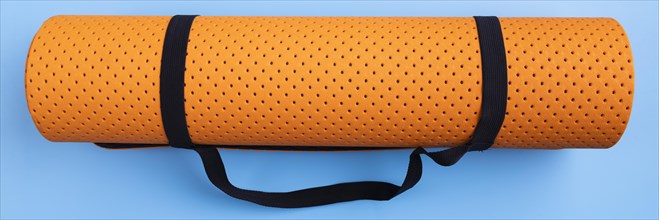 Top view yoga mat blue background