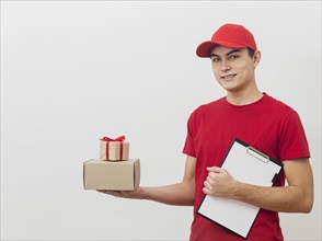 Smiley delivery employee with packages