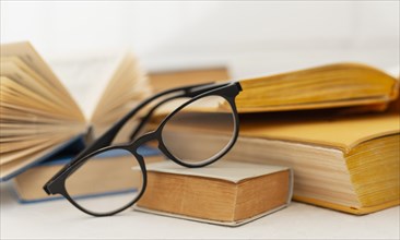 Arrangement with books glasses