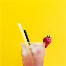 Misted glass cocktail with strawberry straws