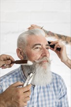 Senior customer getting beard hair care
