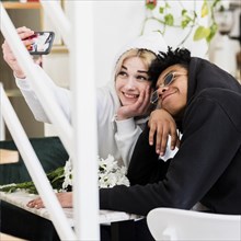 Cute happy interracial teenage young couple taking selfie mobile phone