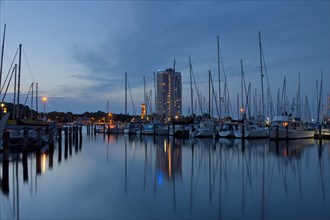 The Maritim Hotel and sailing boats in marina at dusk