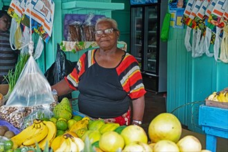 Black woman selling fruit in shop in capital town Port Elizabeth on the island Bequia