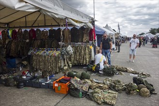 Military uniforms and battle dresses for sale in booth at militaria fair