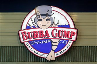 Electronic sign for Bubba Gump shrimp restaurant inside Cancun airport