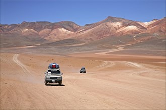 Four-wheel drive vehicles driving on dirt-track on the Altiplano in Bolivia
