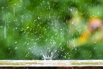 Raindrop falls on a garden table