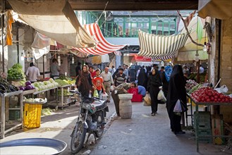 Iranians buying food at vegetable market in the city Gorgan
