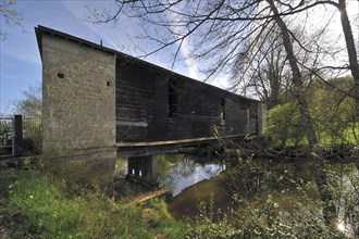 Wooden covered bridge over the river Bouzanne at Le Pont-Chretien-Chabenet