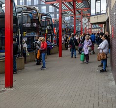 People and buses in bus station in the town centre