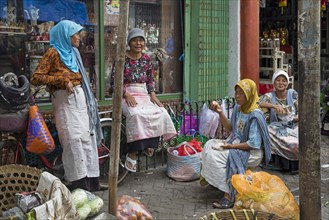 Javanese women chatting at market in Chinatown