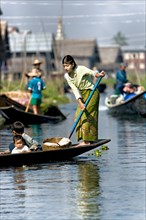 Woman with small children in a boat at Inle Lake