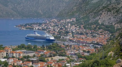 View over the city Kotor and cruise ship moored in the Mediterranean port on the Bay of Kotor