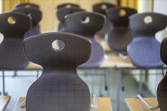 Chairs on school desks in a deserted classroom in Bavaria. Bavaria
