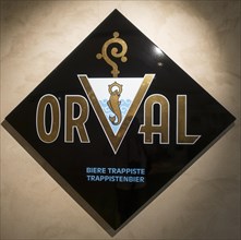 Logo of the Orval Trappist beer on diamond shaped enamelled plate at the Orval Abbey