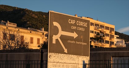 The signpost welcomes travellers at the port exit of Bastia when they arrive by ferry on the Mediterranean island of Corsica