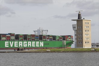 The container ship Ever Goods of the Evergreen shipping company passes the radar tower in Cuxhaven