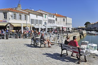 Tourists at pavement cafe in the port at Saint-Martin-de-Re on the island Ile de Re