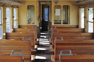 Old passenger carriage with wooden benches at the depot of the Chemin de Fer a Vapeur des Trois Vallees at Mariembourg