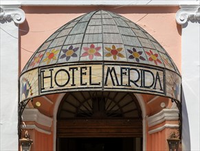 Stained glass canopy entrance to colonial style Hotel Merida