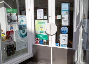 Advertisting information posters in pharmacy shop doorway