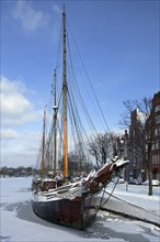 Sailing ship in the snow in winter in the harbour museum at the Hanseatic City of Luebeck