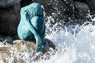 Spring storms churn up the sea. Here they wash around the statue of the mermaid in the harbour of L'ile-Rousse in the northwest of the Mediterranean island of Corsica