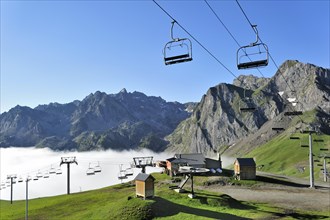 Empty chairlift in the mist at sunrise along the Col du Tourmalet in the Pyrenees