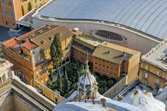 Bird's eye view of German cemetery in the Vatican next to St. Peter's Basilica in the background next to it roof of audience hall for audience with Pope