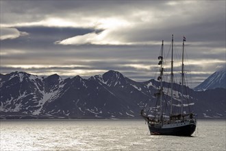 View over mountain range and the tall ship