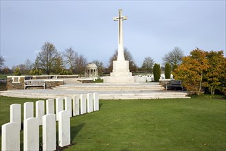 Cross of Sacrifice at the Bedford House cemetery with graves of First World War British Empire soldiers at Zillebeke near Ypres