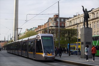 A Luas tram in O'Connell Street with pedestrians visible too. Dublin