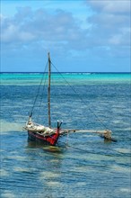 Traditionesses Dugout Canoe Dugout canoe lies in turquoise blue lagoon of Yap Island in Pacific Still Ocean