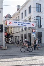 Banner indicating walking direction for shoppers in shopping street during 2020 COVID-19