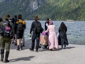 Hikers in traditional Bavarian traditional costume at Koenigssee in Berchtesgaden National Park