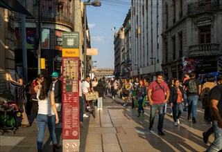 Crowd of people on pedestrianised street Avenida Madero