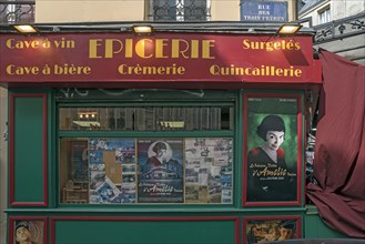 Movie posters from the film The Fabulous World of Amelie in the window of the Collignon grocery shop