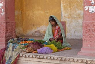 Indian women dressed in sari selling vegetables in the town Bundi