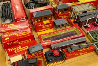 Boxes of vintage Tri-ang Railways scale model toy train set on display in auction room